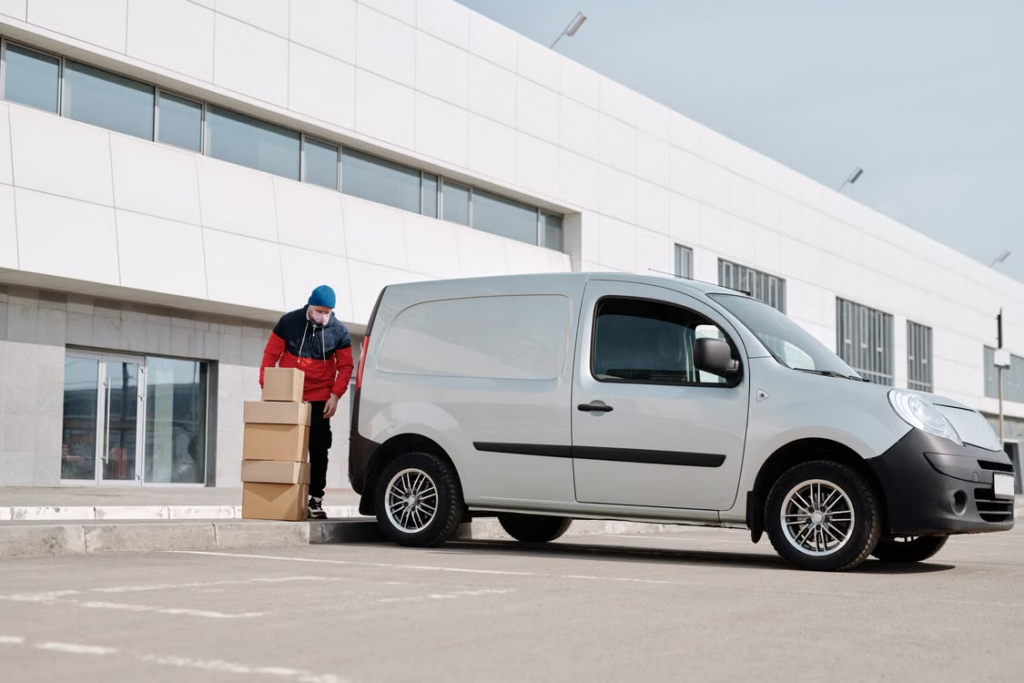 Delivery driver handing over an international preorder package to a customer.