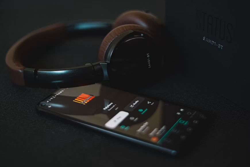 Streaming anime soundtracks through a music streaming service on a smartphone.