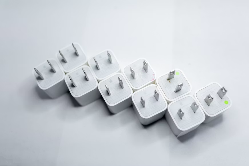 Electronics and power plugs representing compatibility before international purchase.